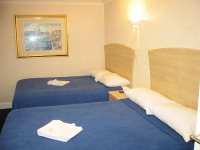 A quad room at Alhambra Hotel