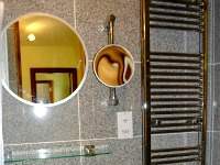Convenient mirrors and heated towel racks feature in your modern, private ensuite bathroom