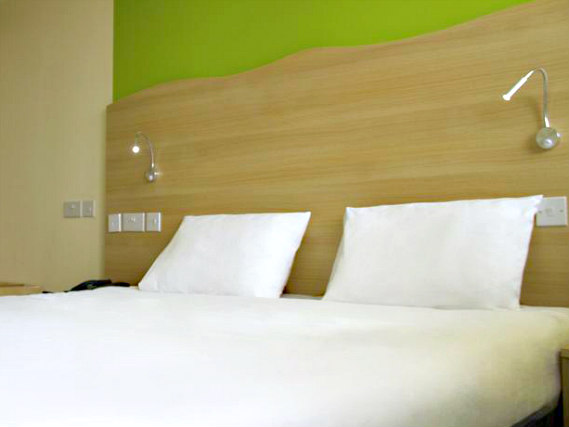 Put your feet up in front of the TV in your room at Best Western Queens Crystal Palace Hotel