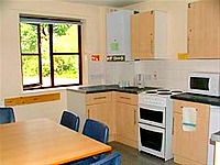 A typical kitchen and lounge area where you can make your own meals, helping to save money