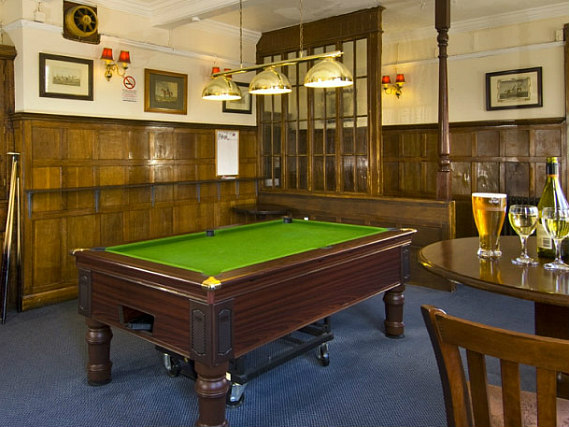 Watch TV in the lounge at Master Robert Hotel